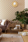 Patterned wallpaper in living room decorated in gold and mauve at Christmas