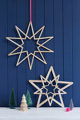 Stars handmade from wooden lolly sticks against blue board wall