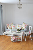 Pallet table, chair and sofa with floral scatter cushions