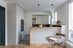 Moderne offene Küche mit hellgrauen Einbaumöbeln