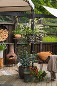 Planters and vintage-style accessories on cosy terrace in garden