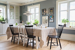 Black and white chairs around set table in dining room
