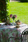 Romantically set tea table in summery château garden