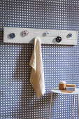 Handmade coat rack with industrial valve handles as hooks in bathroom