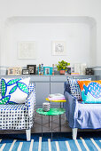 Blue-and-white, polka-dot, loose-covered armchairs with decorative scatter cushions
