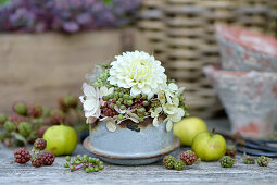 Autumn arrangement with dahlia, hydrangea blossoms and unripe berries