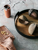 Dried seed pods on tray and accessories in shades of brown
