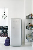 Retro fridge and wire baskets next to dining room doorway