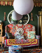 Spherical lampshades and colourful, exotic accessories in living room