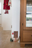 Tiny door for Christmas elves next to cupboard