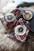 Tartan sachets with numbered paper rosettes