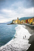 People walking along beach in Camogli, Liguria, Italy