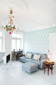 Chandelier, pale blue paper and white floor in living room