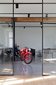 Motorbikes in living room with glass and steel wall