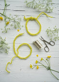 Cow parsley, buttercups and number 60 made from wire wrapped in felt ribbon