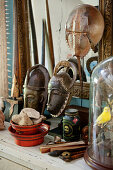 Collection of curiosities including masks, flea-market finds and horseshoe crab