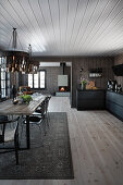 Kitchen counter in modern, open-plan interior of wooden house