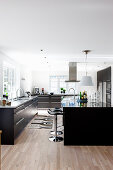Black fitted cabinets in large modern kitchen