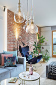 Glass ceiling lamps in living room with brick wall