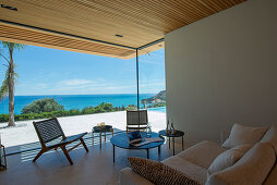 Living room with window bay in modern, architect-designed house with sea view