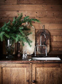 Rustic kitchen base cabinet with sink, fir branches in vase