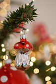 Christmas-tree decoration in shape of fly agaric mushroom and sparkling lights