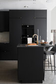 Fitted kitchen with island counter in dark charcoal grey