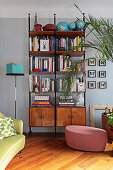 Retro shelves against grey wall in living room with wooden floor