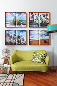 Four holiday photographs above small, green, retro sofa in living room