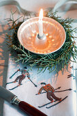 Small bundt cake pan as a candle holder in a wreath made from Arizona cypress