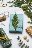 Festively wrapped gift decorated with thuja twig