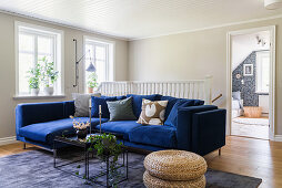 A blue corner sofa in a bright living room