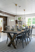 A wooden table with grey lacquered chairs in a Scandinavian dining room