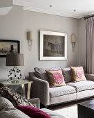Equestrian artwork above sofa with rose cushions