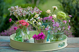 Small bouquets of carnations, Rose campion, sweet William and Armeria on a round tray