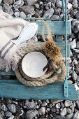 Maritime souvenirs on weathered chair on beach