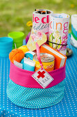 Storage basket made of polka-dotted fabric with magazines and presents