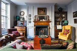 Antiques in classic living room with open fireplace