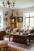 Living room with antique furniture and leather couch