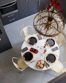 View down onto chandelier above dining table in kitchen-dining room