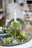 Silver candlestick with green hydrangeas as nostalgic decorations