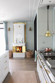 Open-plan kitchen with white, Swedish tiled stove