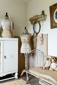 Tailor's dummy and old metal bed in shabby-chic living room