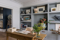 Grey shelf cabinet and wooden desk in the study