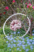 Wreath of apple blossom branches on an old bicycle rim