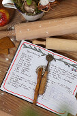 Handwritten recipe card, pastry wheel, and rolling pin