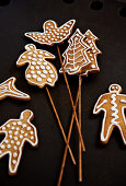 Decorated gingerbread shapes on wooden skewers