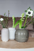 Spring flowers in ceramic vases: anemone, waxflower, hyacinths, star-of-Bethlehem, lisianthus and cherry branch