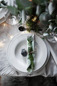 Christmas decoration and fir branch arranged on plate