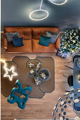 Overhead view of Christmas gifts laid out on the rug, leather sofa and Christmas tree